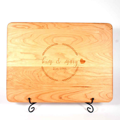 Cherry cutting board laser engraved with couples first names and year of marriage - Dailey Woodworking