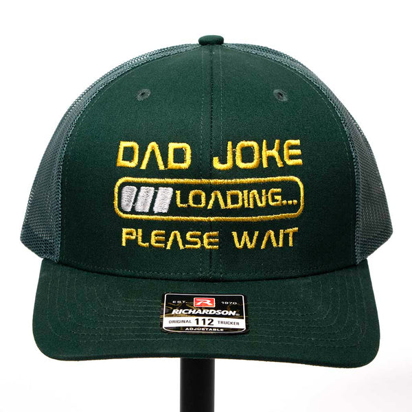 Green front and green mesh back with "Dad Joke Loading Please Wait" Emboidered in yellow and silver stitching. Richardson 112 Hat. 