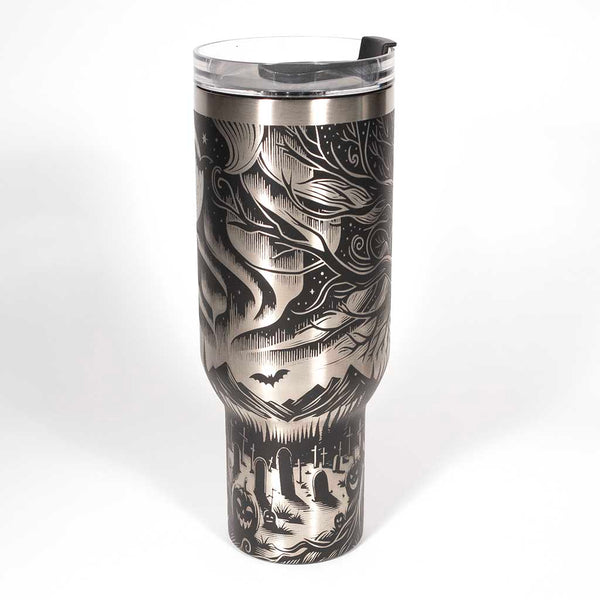 This is a black 40 ounce tumbler with a screw on lid with a drinking hole access and a straw. The laser engraving is of the northern lights, full moon with bats flying, gravestones and ghoulish pumpkins near a tree . Side 2