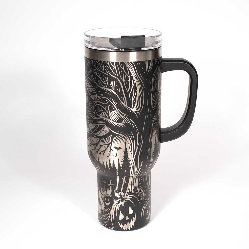 This is a black 40 ounce tumbler with a screw on lid with a drinking hole access and a straw. The laser engraving is of the northern lights, full moon with bats flying, gravestones and ghoulish pumpkins near a tree . Side 3