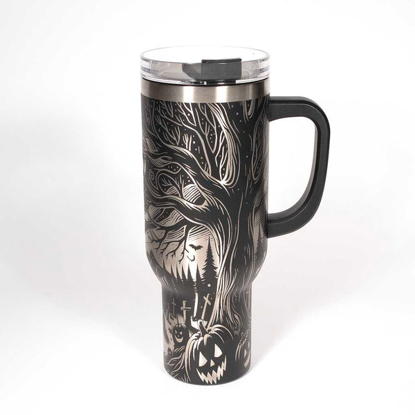 This is a black 40 ounce tumbler with a screw on lid with a drinking hole access and a straw. The laser engraving is of the northern lights, full moon with bats flying, gravestones and ghoulish pumpkins near a tree . Side 3