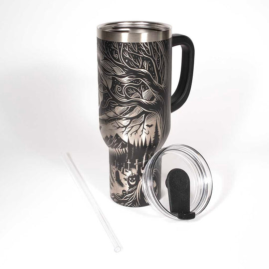 This is a black 40 ounce tumbler with a screw on lid with a drinking hole access and a straw. The laser engraving is of the northern lights, full moon with bats flying, gravestones and ghoulish pumpkins near a tree . Shown with lid removed and straw.