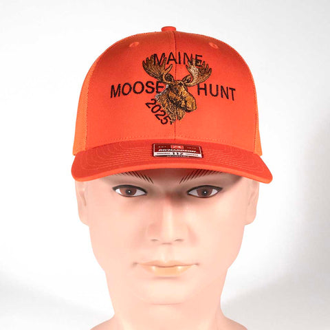 Orange cap with 'Maine Moose Hunt 2025' text and moose graphic on a mannequin head against a white background. From the front. 