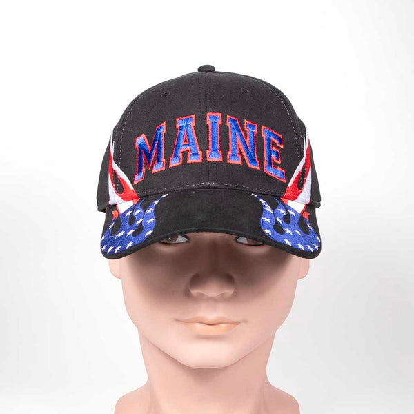 Black cap with 'MAINE' text and red, white and blue flame design on a mannequin head against a white background. Close up view. 