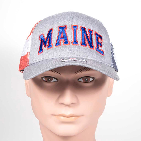 Gray cap with 'MAINE' in red and blue on a mannequin head with red, white and blue mesh back. Side 1
