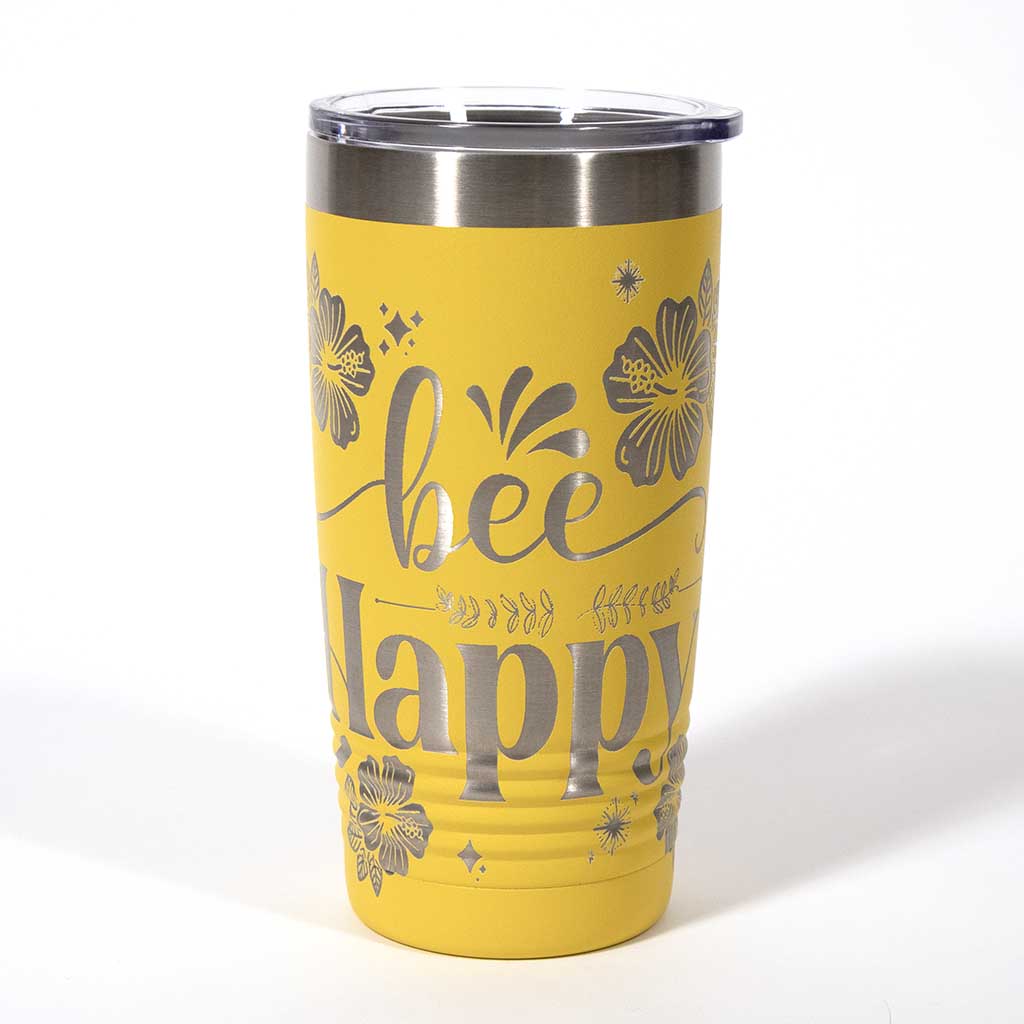 Yellow powder coated 20 ounce stainless steel tumbler. Engraved with flowers, a honeycomb and a bee with the words "Bee Happy". Side 1