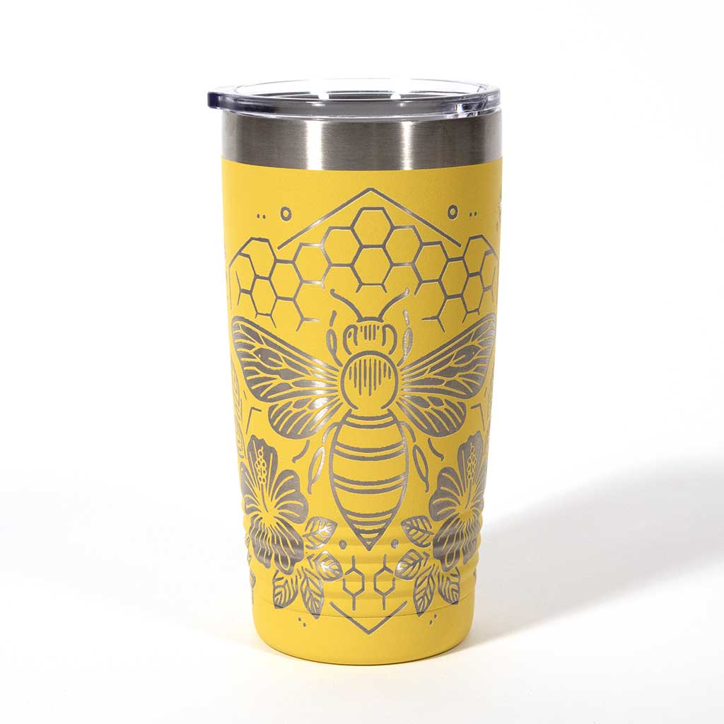 Yellow powder coated 20 ounce stainless steel tumbler. Engraved with flowers, a honeycomb and a bee with the words "Bee Happy". Side 2