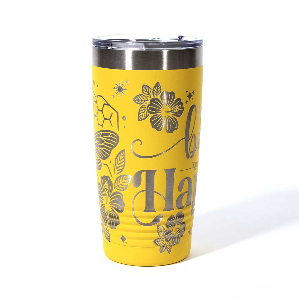 Yellow powder coated 20 ounce stainless steel tumbler. Engraved with flowers, a honeycomb and a bee with the words "Bee Happy". Side 3