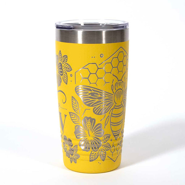 Yellow powder coated 20 ounce stainless steel tumbler. Engraved with flowers, a honeycomb and a bee with the words "Bee Happy". Side 4
