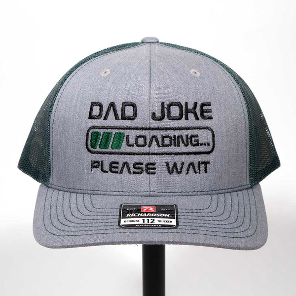 Gray and black cap with 'Dad Joke Loading Please Wait' text on a white background. Richardson 112 hat. 