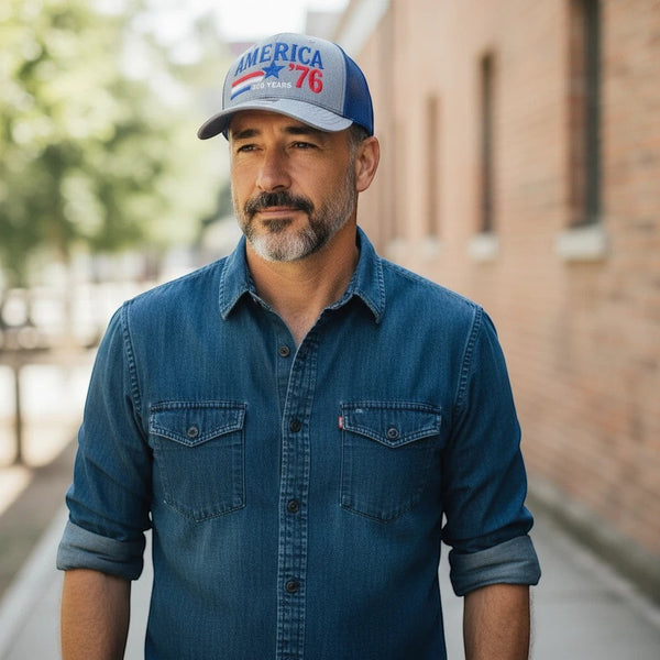 Dailey Woodworking trucker hat with gray front and blue mesh back, featuring patriotic America 250 embroidery on a man