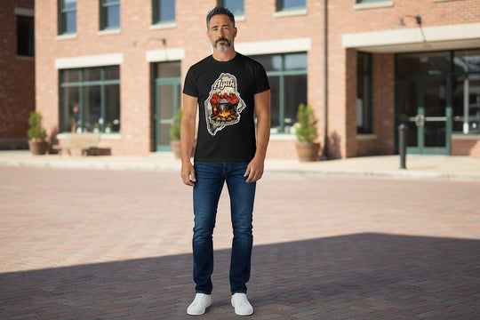 Black t-shirt with a graphic of the state of Maine containing a lobster pot over a fire with lobsters sitting inside and the words "Ayuh" and "The way life should be"