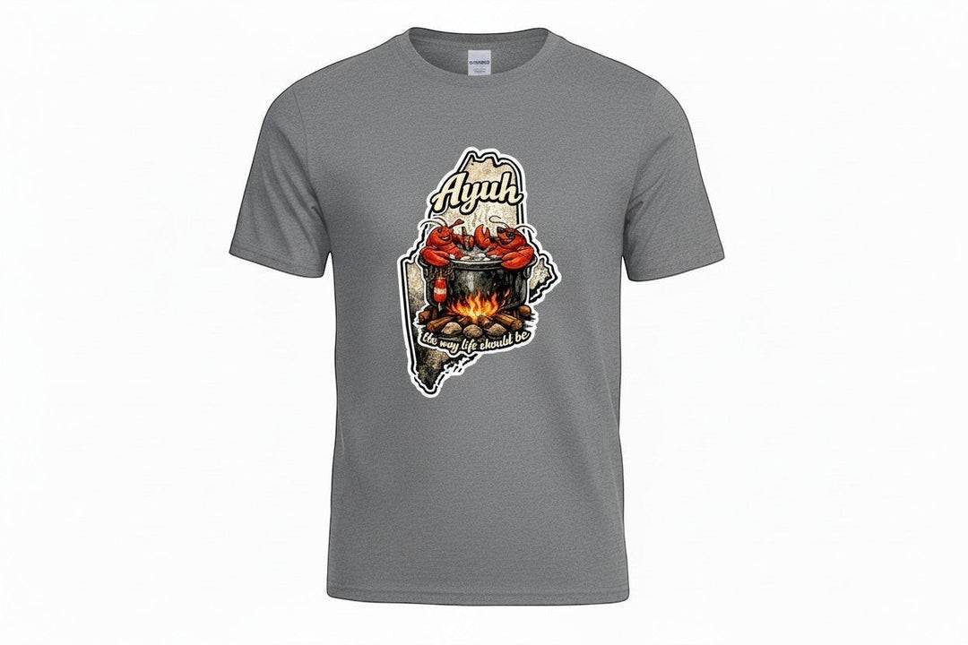 Gravel colored t-shirt with a graphic of the state of Maine containing a lobster pot over a fire with lobsters sitting inside and the words "Ayuh" and "The way life should be"