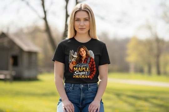 Dailey Woodworking black short sleeve t-shirt with a graphic of a woman in overalls holding a maple leaf bottle of syrup.