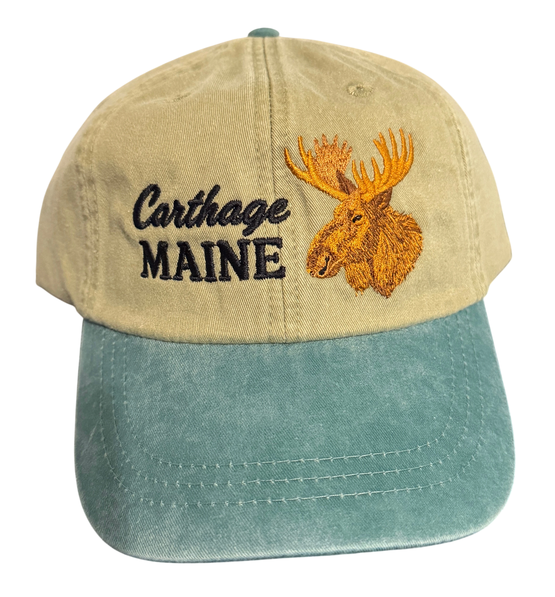 Dailey Woodworking Carthage Maine moose embroidered dad hat in vintage tan and teal garment-washed cotton.