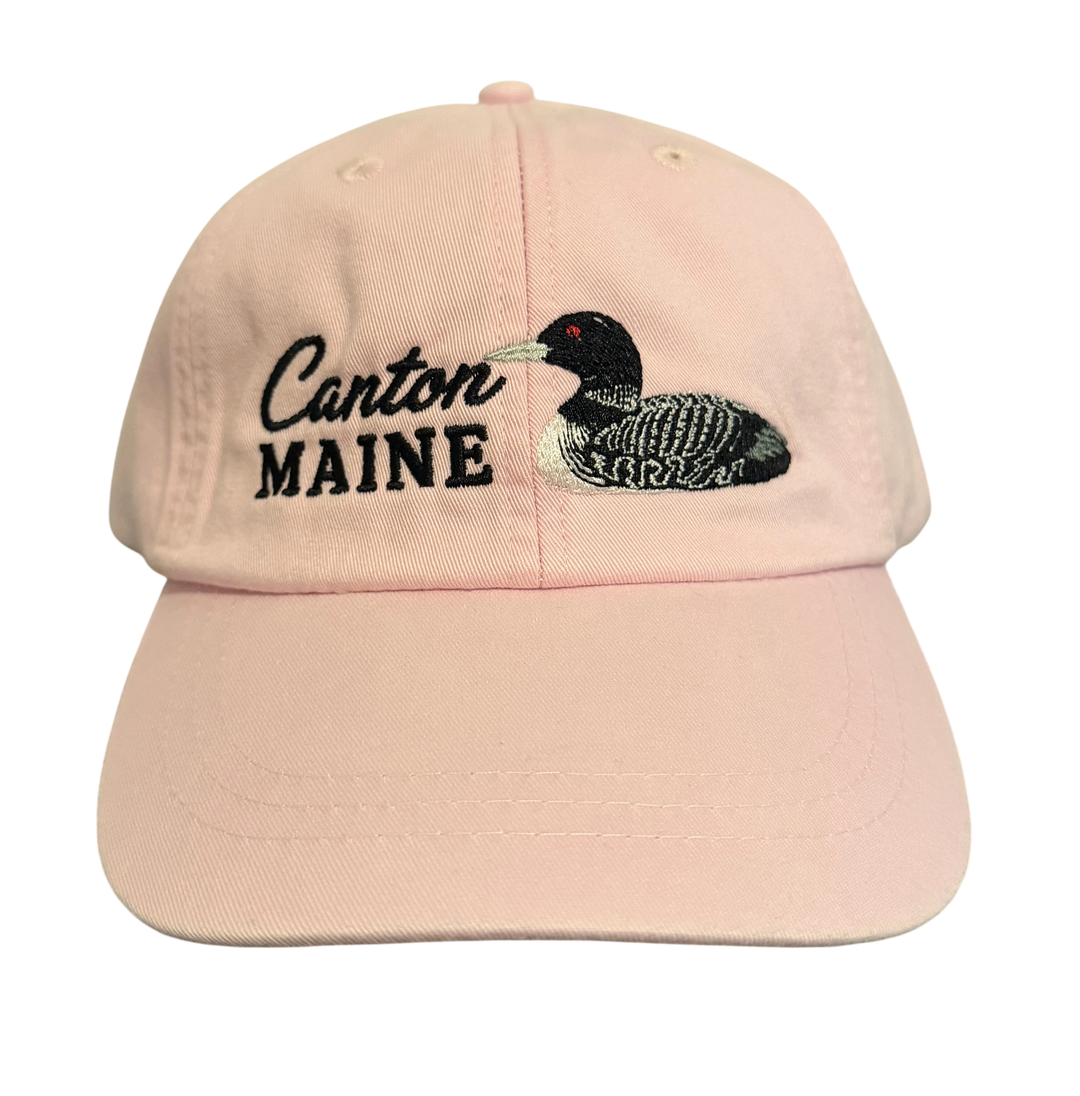 Dailey Woodworking light pink cotton baseball cap featuring embroidered Canton Maine text and a detailed loon design.