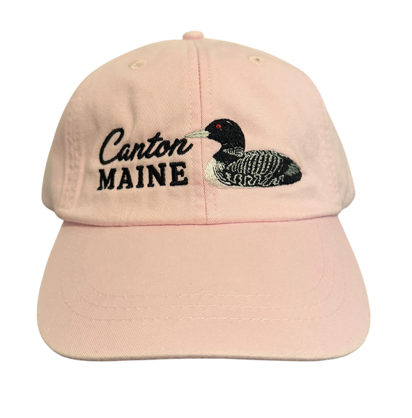 Dailey Woodworking light pink cotton baseball cap featuring embroidered Canton Maine text and a detailed loon design.