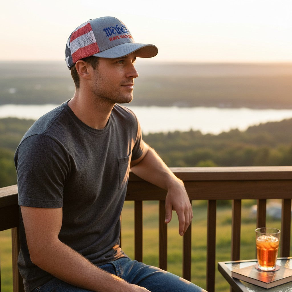 Dailey Woodworking trucker hat with We The People embroidery, heather grey front, and stars-and-stripes mesh back