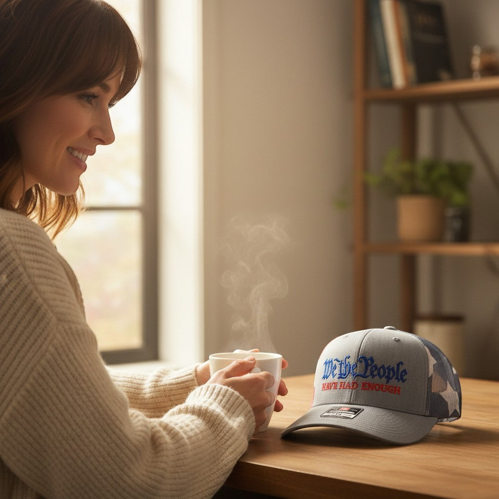 Dailey Woodworking Richardson 112 trucker hat with We The People embroidery on a wooden table next to a woman