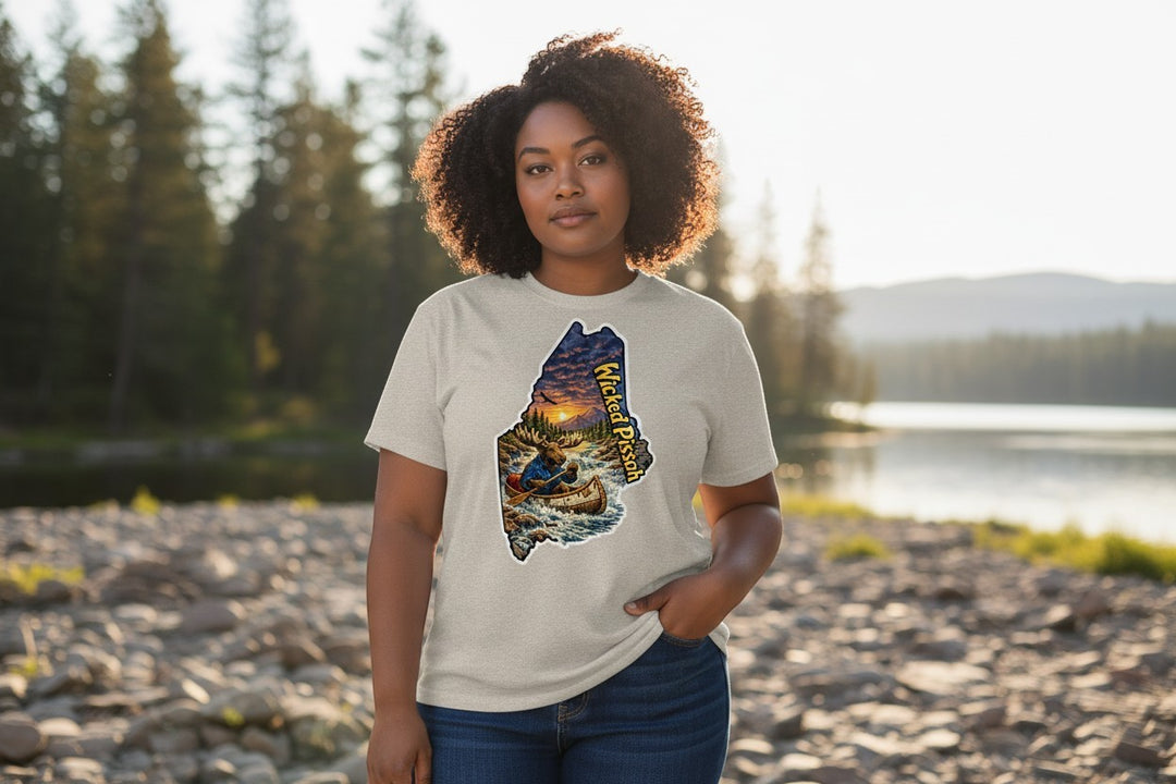 Dailey Woodworking light grey short sleeve t-shirt with a graphic of Maine featuring a moose in a canoe, sunset, and "Wicked Pissah" text.