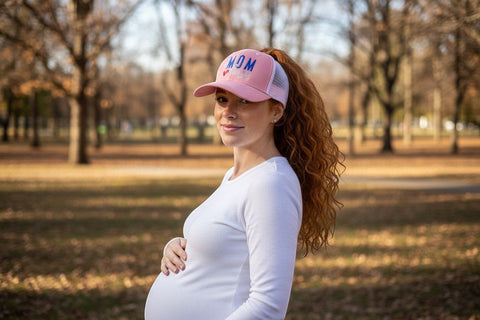 Dailey Woodworking dusty rose trucker hat with white mesh back, embroidered with "Wife Mom Boss" and a red heart.