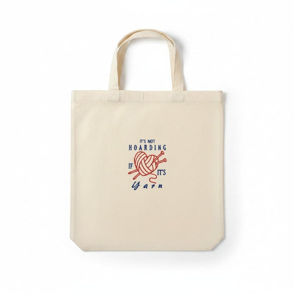 Dailey Woodworking natural canvas tote bag with embroidered "It's Not Hoarding If It's Yarn" text and yarn ball graphic.