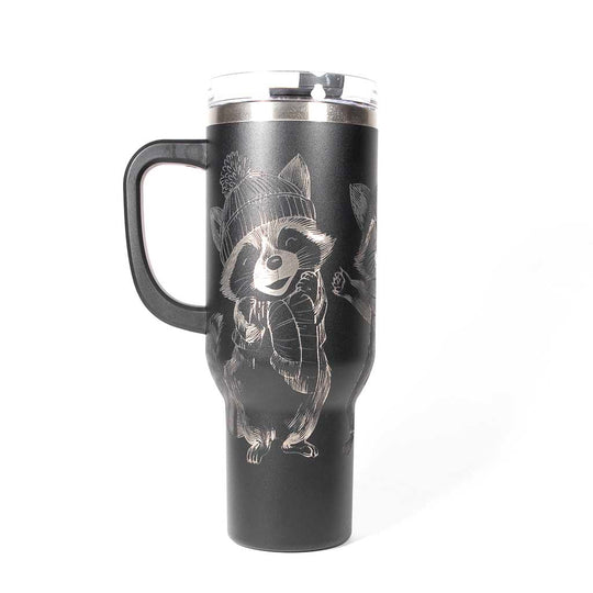 40 ounce black travel mug with three engraved raccoons dressed in scarves and hats. Side 2