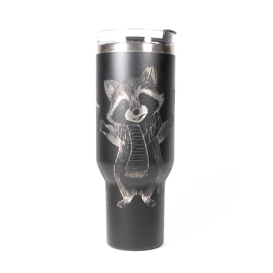 40 ounce black travel mug with three engraved raccoons dressed in scarves and hats. Side 1