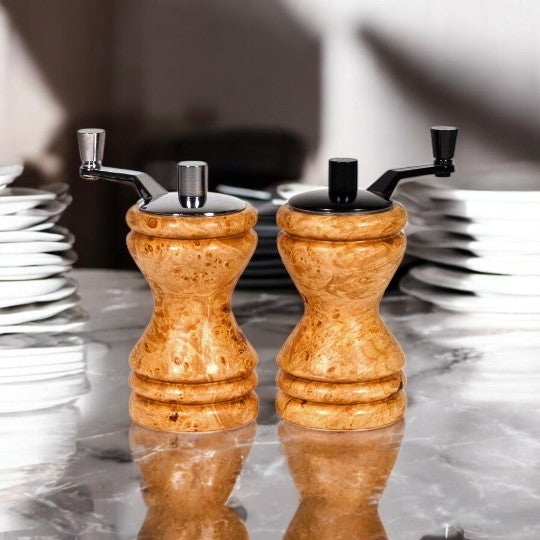 Set of Ferris mini-grinders made in Maple Burl sitting on a dark marble countertop  with blurred kitchen background - Dailey Woodworking
