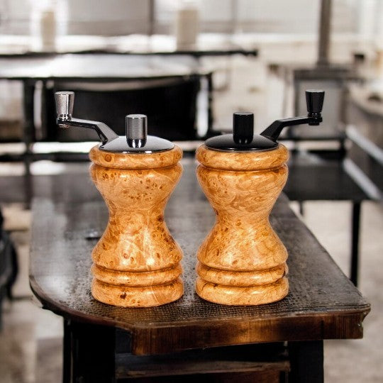 Set of Ferris mini-grinders made in Maple Burl sitting on a dark wooden counter with blurred kitchen background - Dailey Woodworking