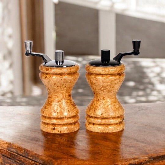 Set of Ferris mini-grinders made in Maple Burl sitting on a wooden counter with blurred scene behind - Dailey Woodworking