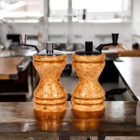 Set of Ferris mini-grinders made in Maple Burl sitting on a wood counter with blurred kitchen background - Dailey Woodworking