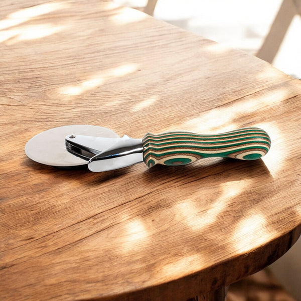 Camo Laminated Pizza Cutter, Pizza Wheel sitting on a wooden table - Dailey Woodworking