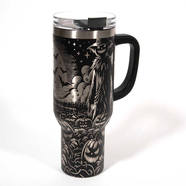 This is a black 40 ounce tumbler with a screw on lid with a drinking hole access and a straw. The laser engraving is of a pumpkin patch, a barn and scarecrow. Side 3