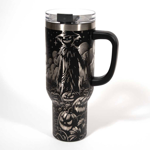 This is a black 40 ounce tumbler with a screw on lid with a drinking hole access and a straw. The laser engraving is of a pumpkin patch, a barn and scarecrow. Side 4