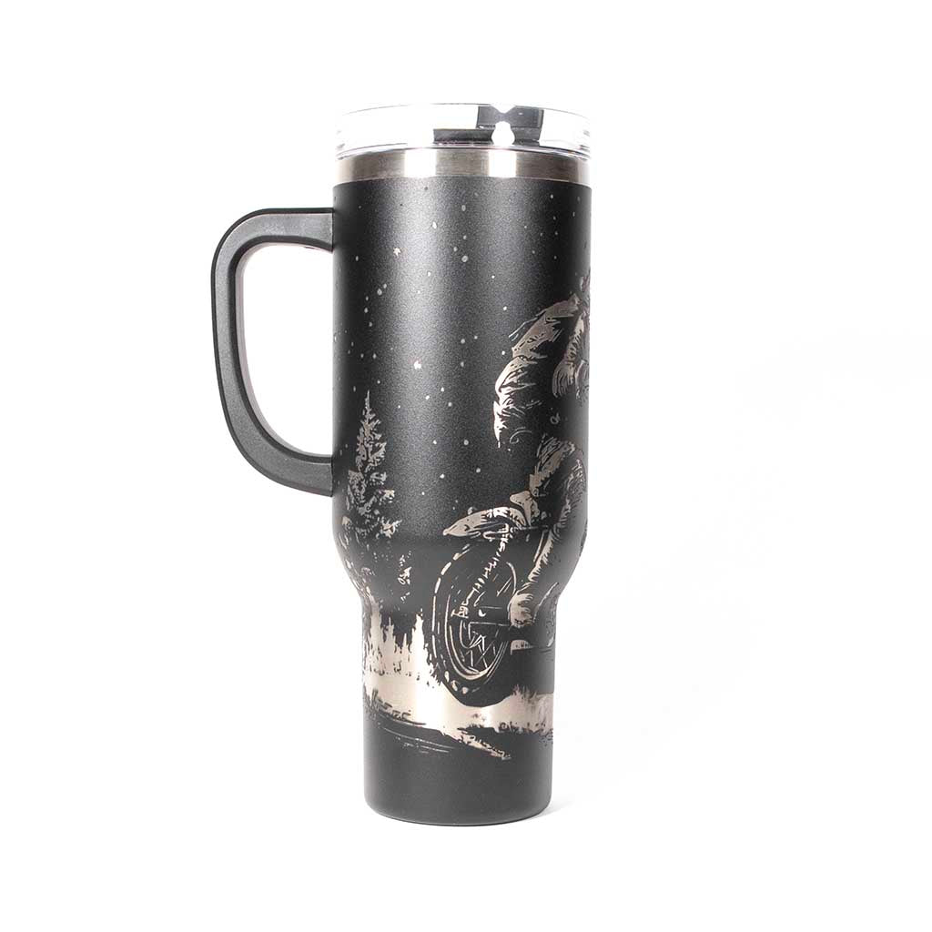 Black 40 ounce travel mug with an laser engraving of Santa taking off into the night on his trusty motorcycle. side 2