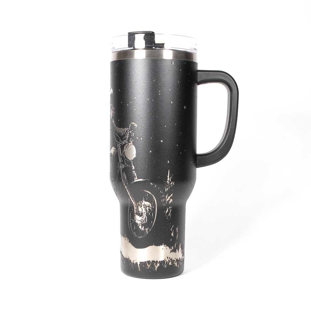 Black 40 ounce travel mug with an laser engraving of Santa taking off into the night on his trusty motorcycle. side 3