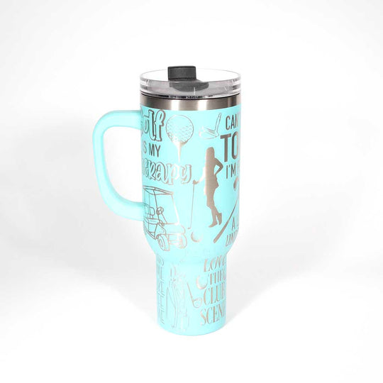 Seafoam 40 ounce travel mug with funny golf sayings and images of a female golfer. 