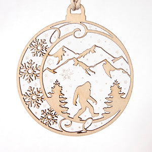Two part ornament, Bigfoot-Sasquatch-Yeti walking through a mountain scene with snowflakes falling all around - Dailey Woodworking